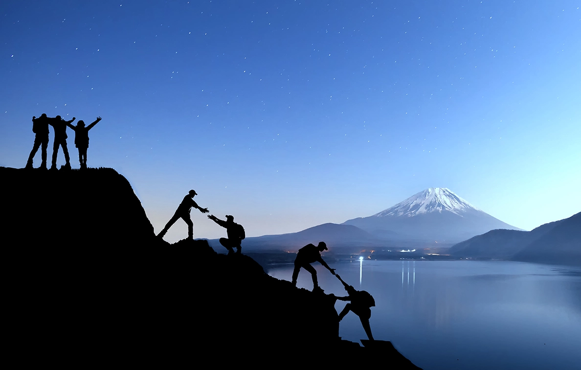 Team ascending a mountain  - representing dedicated customer success partnership